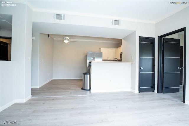 interior space with visible vents, a ceiling fan, and crown molding