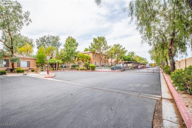 view of street featuring curbs and a gated entry