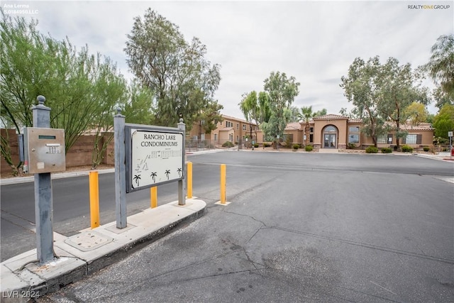 view of street with a gated entry and curbs