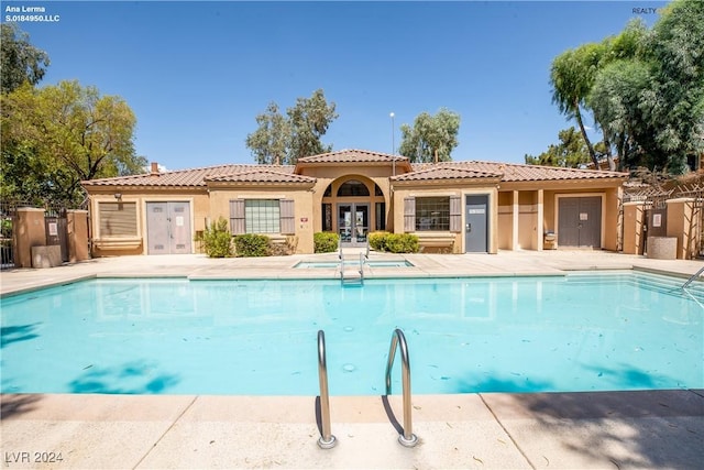 community pool with french doors and fence