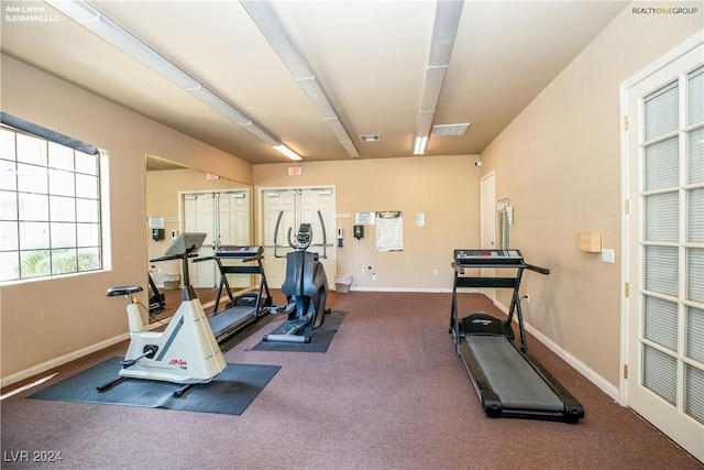 exercise area with baseboards and visible vents