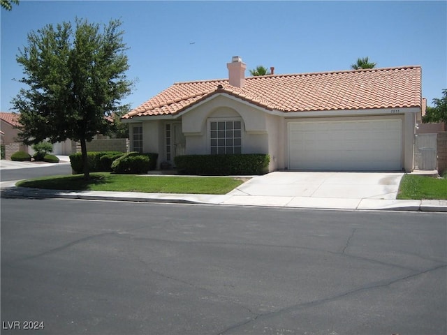 mediterranean / spanish home with a garage