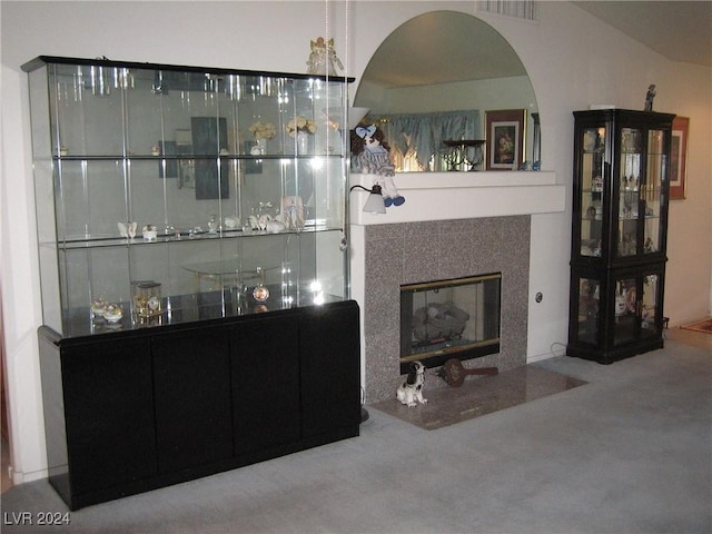 bar featuring carpet floors and a tile fireplace