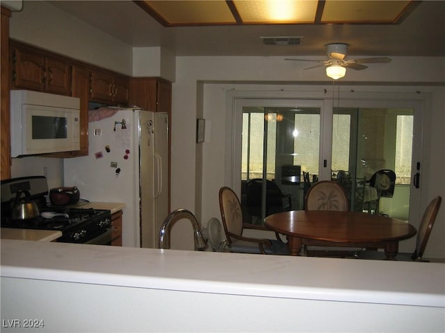 kitchen with french doors, white appliances, ceiling fan, and sink