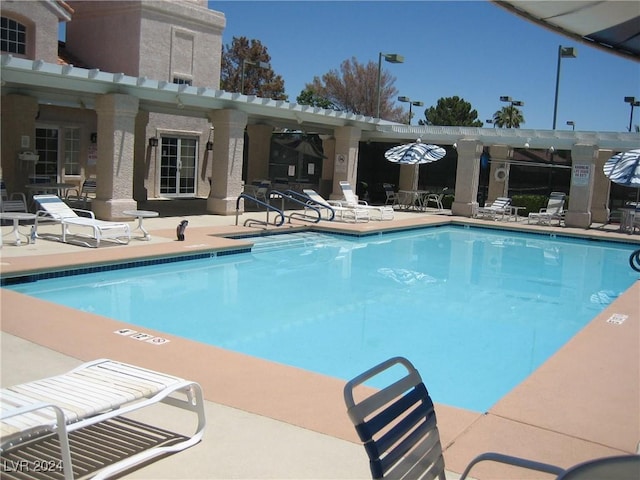 view of swimming pool with a pergola and a patio