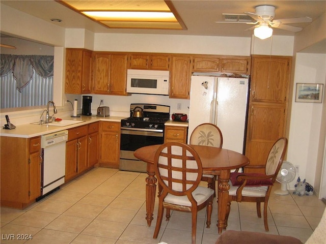 kitchen with ceiling fan, white appliances, sink, and light tile patterned floors