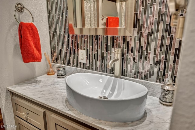 713 Antelope Way, Las Vegas, NV 89145 - bathroom with a textured wall, vanity, and decorative backsplash