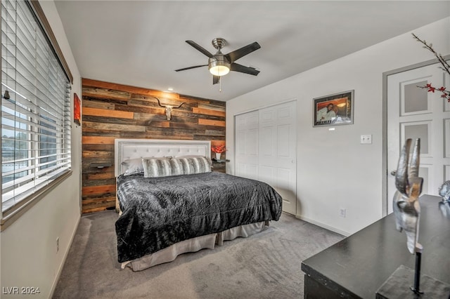 713 Antelope Way, Las Vegas, NV 89145 - bedroom with wooden walls, carpet, a closet, an accent wall, and a ceiling fan