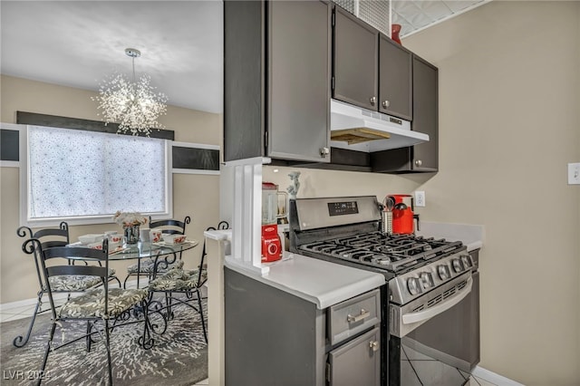 713 Antelope Way, Las Vegas, NV 89145 - kitchen with stainless steel gas stove, under cabinet range hood, a chandelier, and light tile patterned flooring