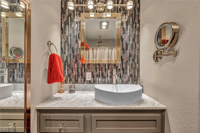 713 Antelope Way, Las Vegas, NV 89145 - full bathroom featuring decorative backsplash, vanity, and a textured wall