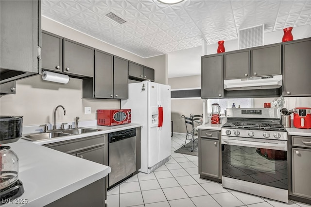 713 Antelope Way, Las Vegas, NV 89145 - kitchen featuring stainless steel appliances, under cabinet range hood, light countertops, light tile patterned floors, and an ornate ceiling