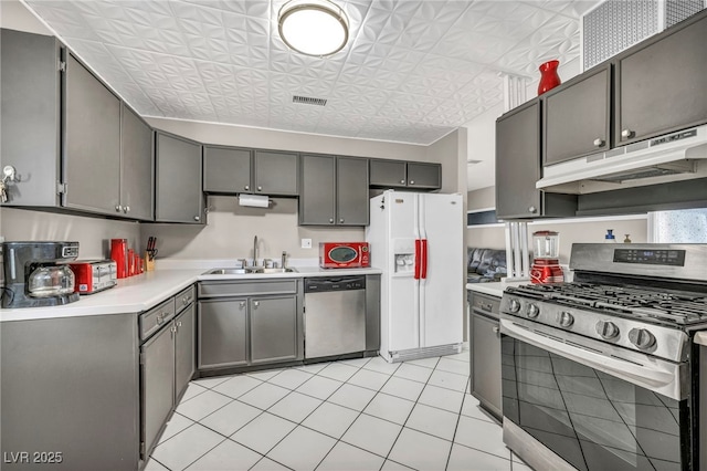 713 Antelope Way, Las Vegas, NV 89145 - kitchen featuring stainless steel appliances, under cabinet range hood, light countertops, an ornate ceiling, and light tile patterned flooring