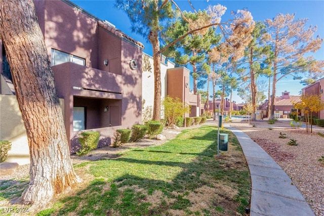 view of home's community with a yard