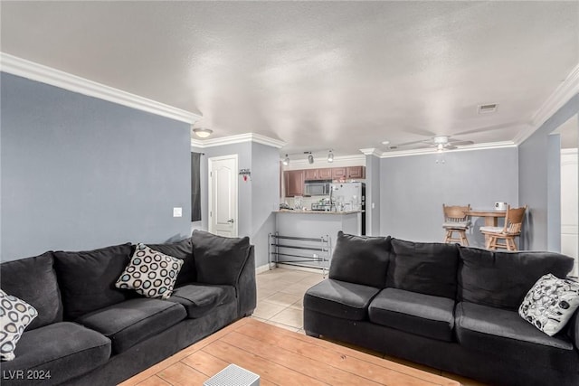 tiled living room with crown molding and ceiling fan