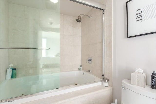 bathroom featuring shower / bath combination with glass door and toilet