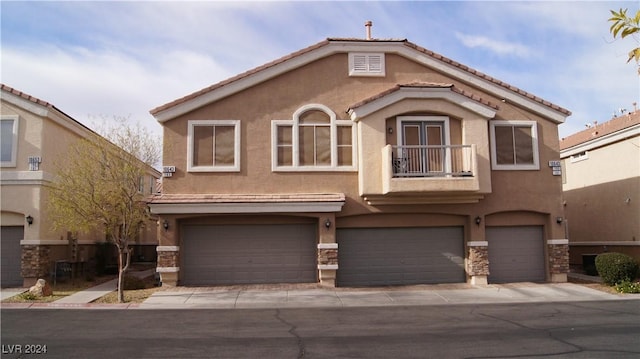 view of front facade with a balcony and a garage