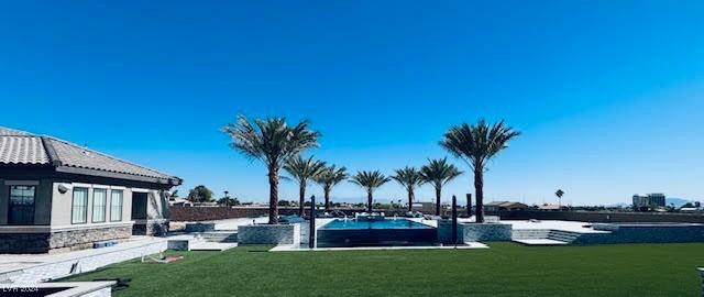 view of pool featuring a yard