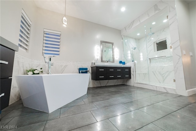 bathroom with vanity and separate shower and tub