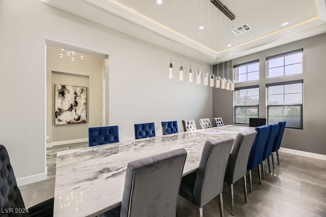 dining space featuring ornamental molding and a tray ceiling