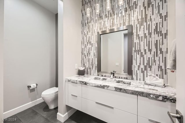 bathroom featuring vanity, toilet, and tile patterned flooring