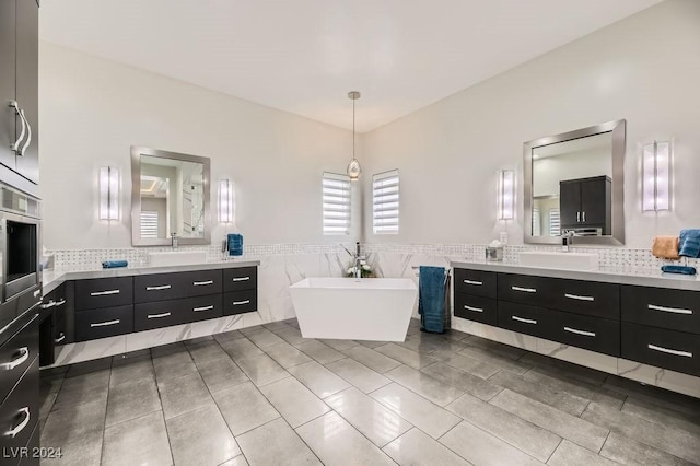 bathroom with vanity, tile walls, and a bathing tub