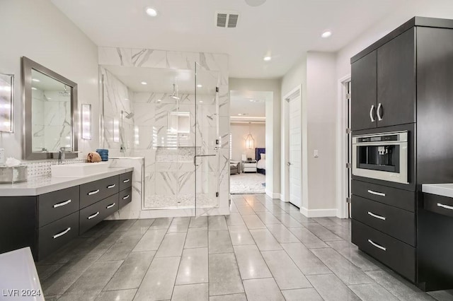 bathroom with vanity and a shower with shower door