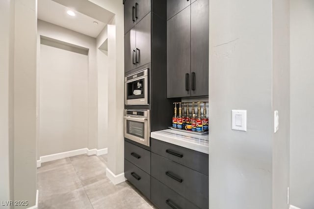 kitchen with oven and light tile patterned floors