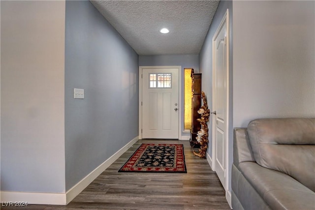 doorway featuring hardwood / wood-style flooring and a textured ceiling