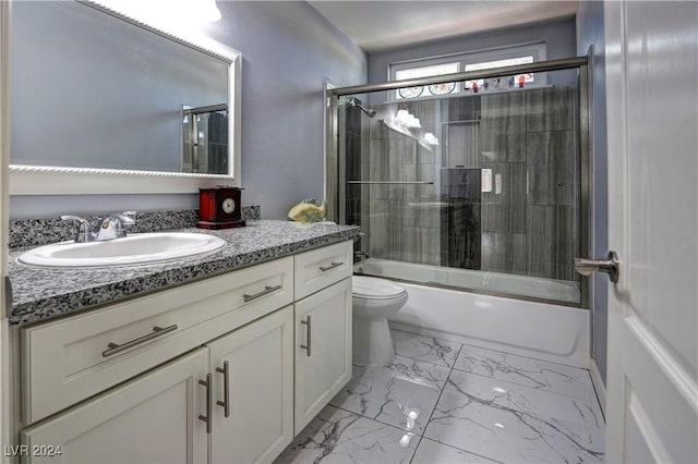 full bathroom with vanity, toilet, and bath / shower combo with glass door