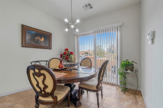 tiled dining room featuring a chandelier