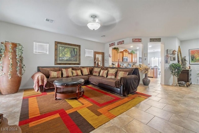 living room with ceiling fan and light tile patterned floors