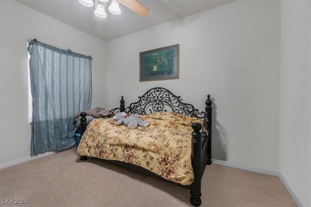 bedroom with ceiling fan and light carpet