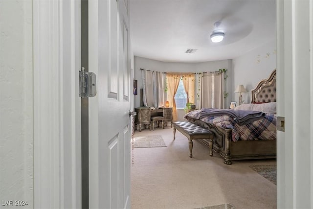 bedroom with ceiling fan and light colored carpet