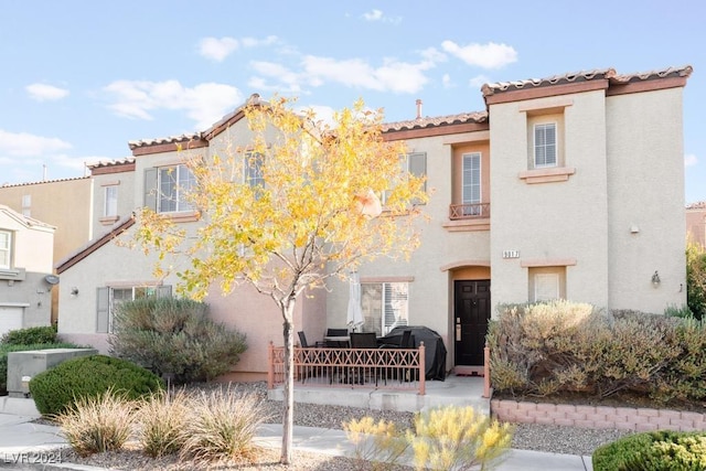 mediterranean / spanish-style home with central AC and a patio