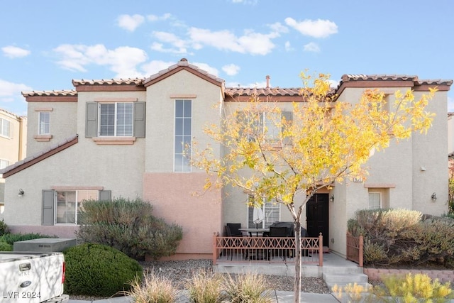 mediterranean / spanish-style house with a patio area