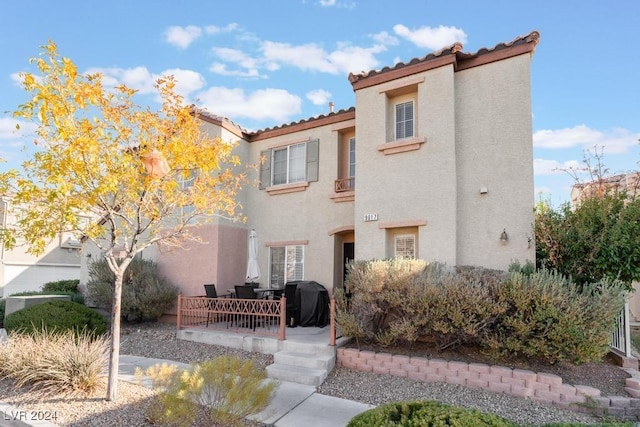 mediterranean / spanish-style home with a patio area