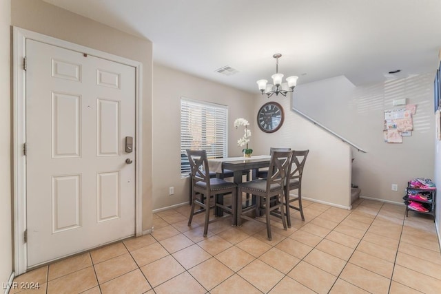 tiled dining space with a notable chandelier