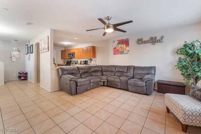 living room with ceiling fan and light tile patterned flooring