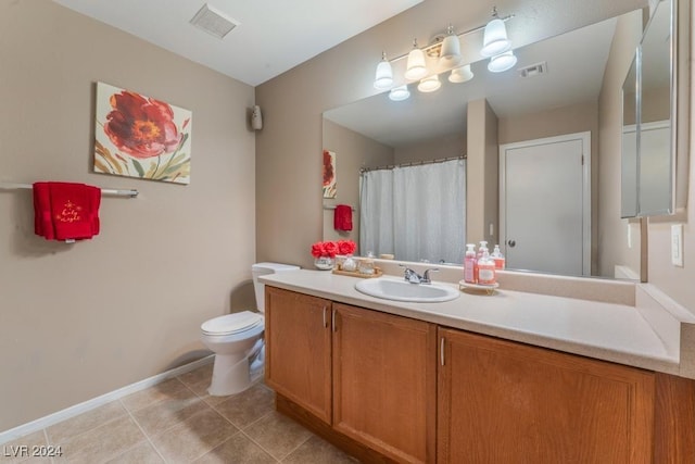 bathroom with vanity, tile patterned floors, and toilet