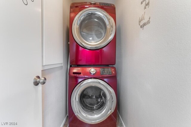 laundry room featuring stacked washer / drying machine