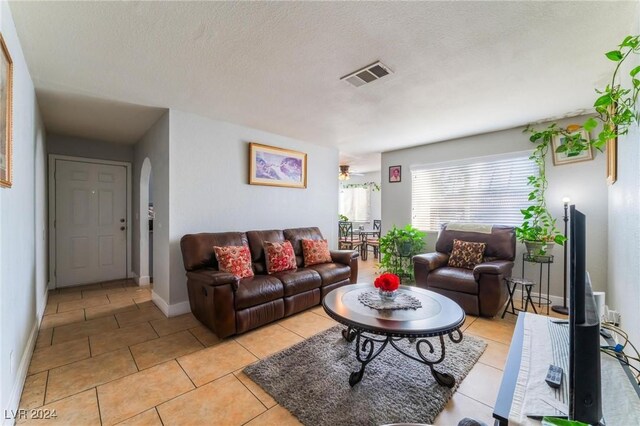 living room with light tile patterned floors and a textured ceiling