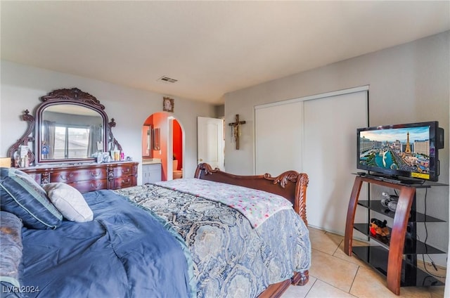 bedroom featuring light tile patterned floors and a closet