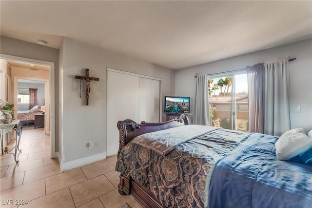 bedroom featuring light tile patterned floors and a closet