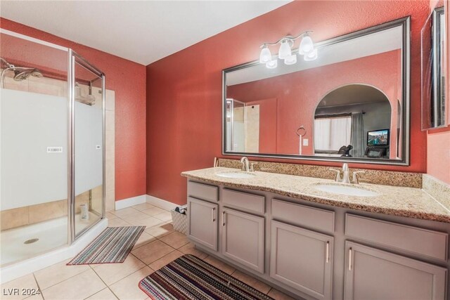 bathroom with tile patterned flooring, vanity, and a shower with shower door