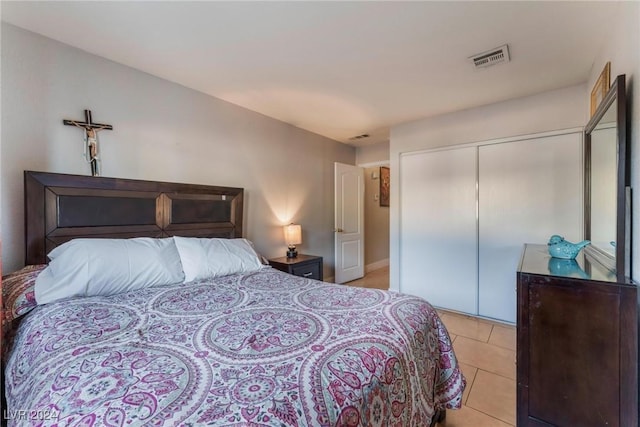 tiled bedroom with a closet