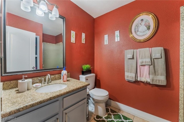 bathroom with tile patterned floors, vanity, and toilet