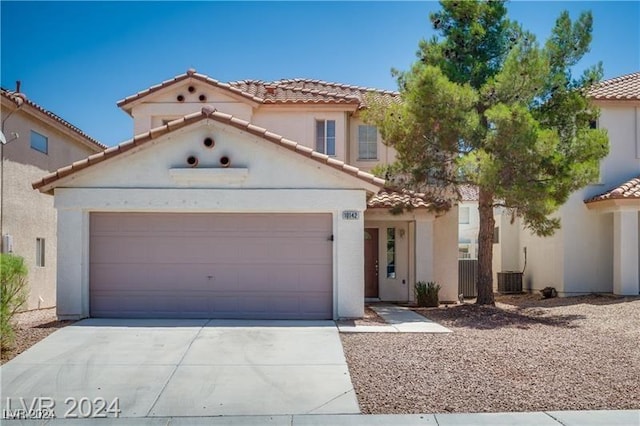 10142 Rice Paper St, Las Vegas, NV 89183 - mediterranean / spanish-style home featuring a tile roof, driveway, stucco siding, and an attached garage