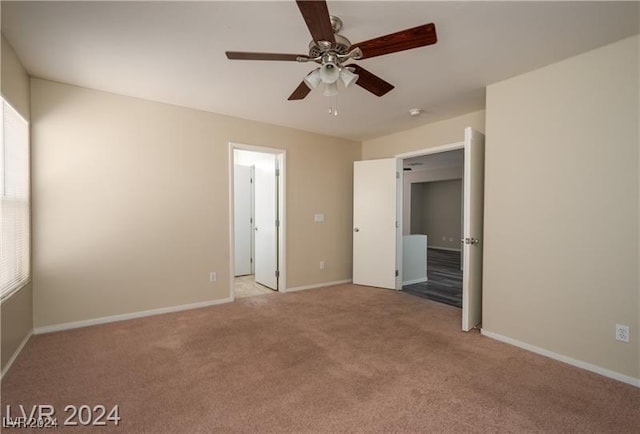 unfurnished bedroom featuring light carpet and ceiling fan