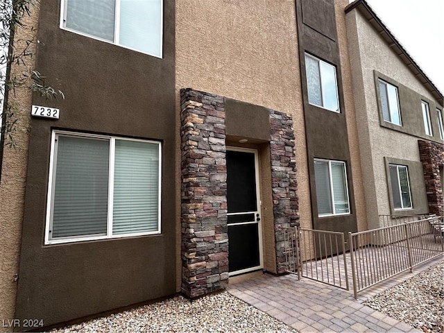 7232 Halo Falls St, North Las Vegas, NV 89084 - entrance to property featuring stucco siding, stone siding, and a patio