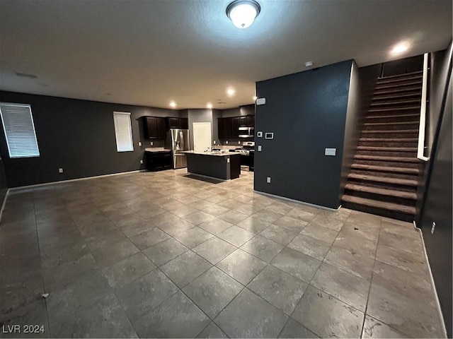 kitchen featuring stainless steel fridge with ice dispenser and a kitchen island